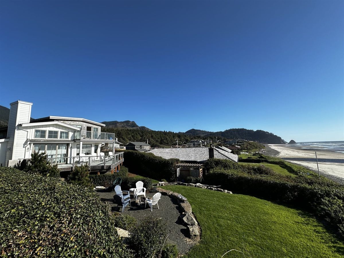 This oceanfront home features a large deck overlooking the beach, complete with Adirondack chairs for sunset watching. It’s the perfect spot to unwind and soak in the beauty of the Pacific.