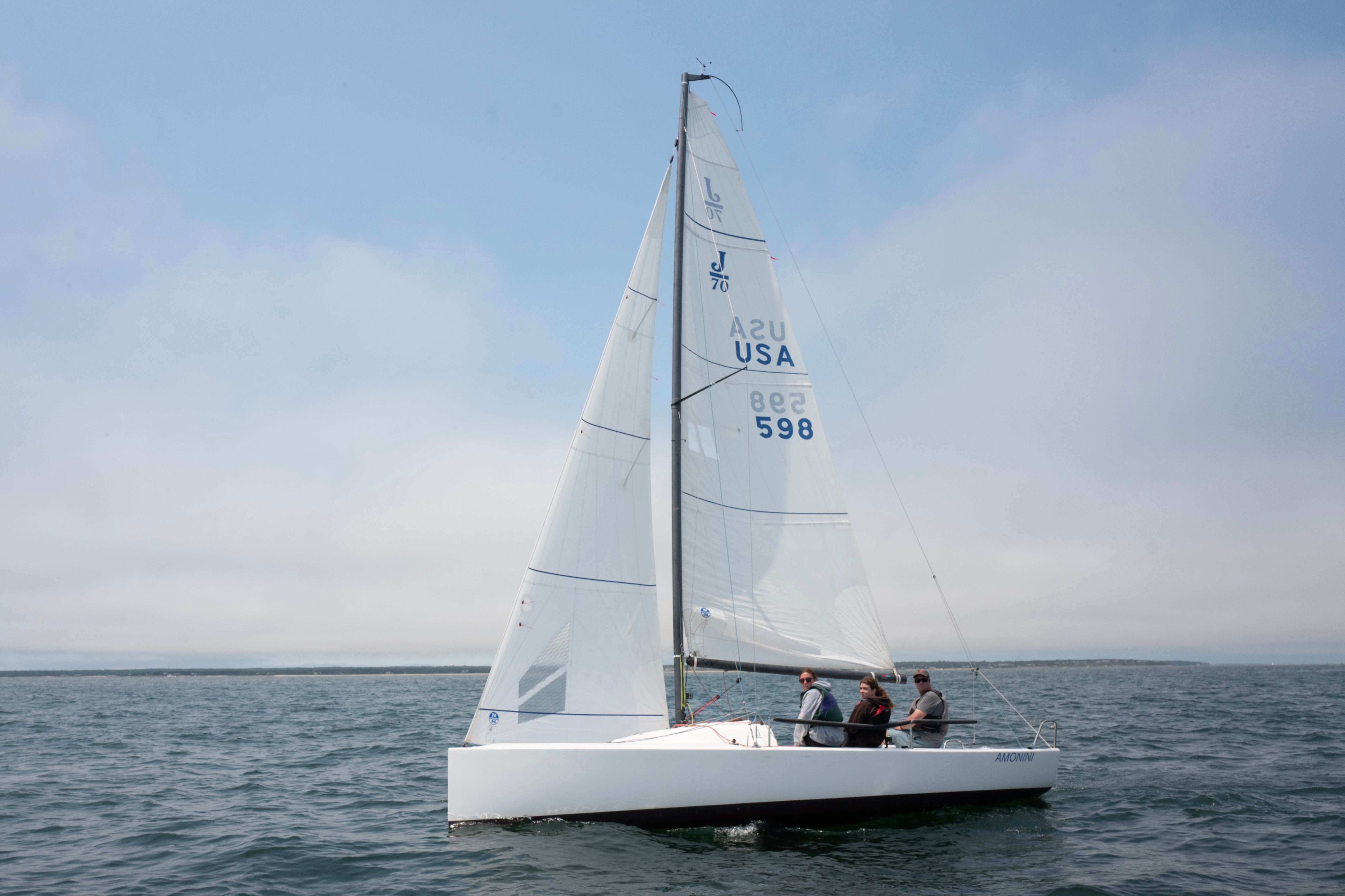Sailors glide across the calm ocean during the Vineyard Cup Regatta, their white sailboat cutting through the blue water. The scene captures the island’s strong maritime spirit and love for sailing.