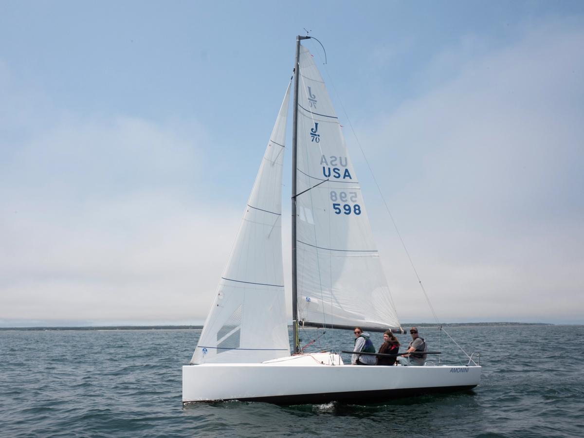 Sailors glide across the calm ocean during the Vineyard Cup Regatta, their white sailboat cutting through the blue water. The scene captures the island’s strong maritime spirit and love for sailing.