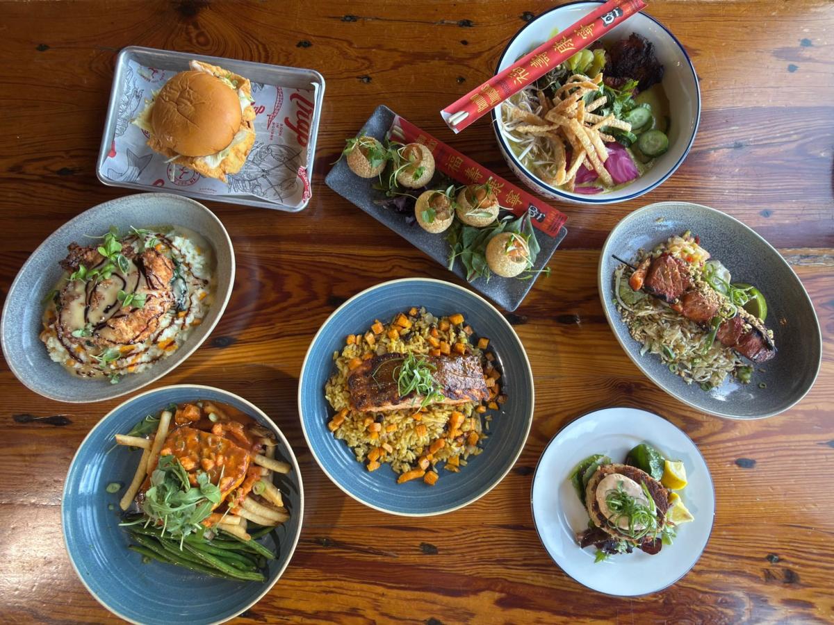 Guests dining outdoors on a scenic patio overlooking the water on a sunny day. The waterfront setting makes this restaurant a relaxing place to enjoy fresh seafood and drinks. Outdoor dining like this is one of the best ways to experience the charm of coastal restaurants.