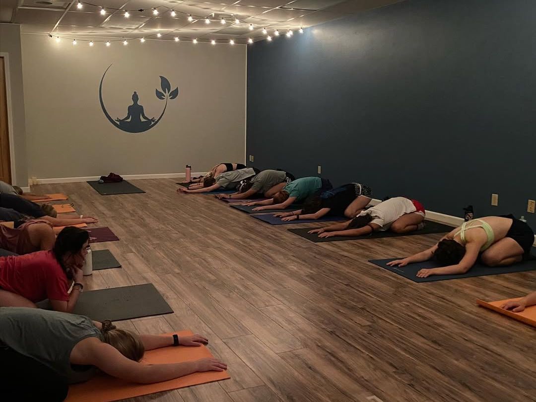 Firefly Yoga and Wellness offers group classes in a cozy studio lit with string lights. Guests find peace and strength through yoga flows in this inviting community space.
