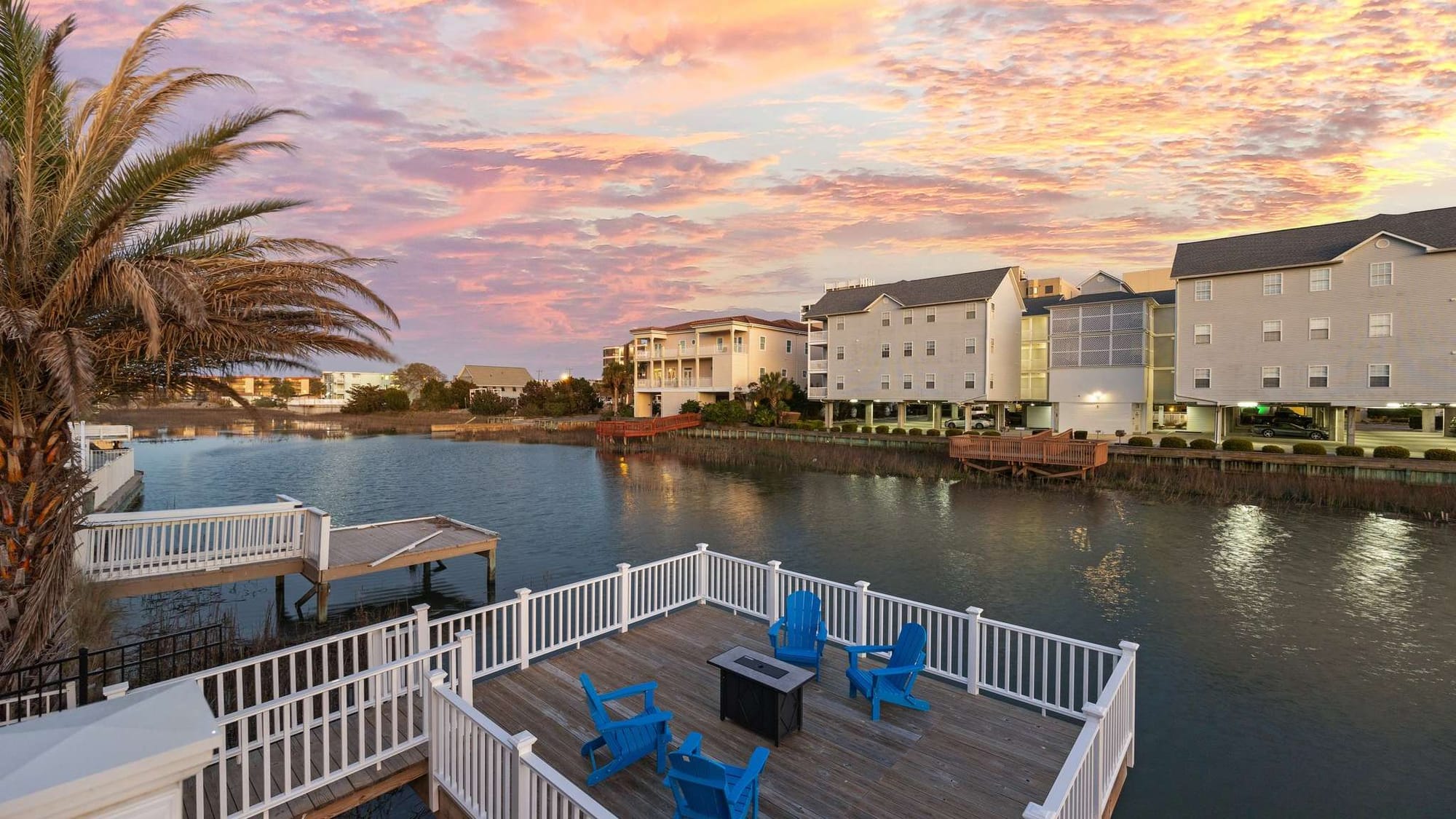 Nestled by the channel, this charming home features a softly lit pool area surrounded by modern lounge chairs. It’s the kind of place where you can sip a drink at sunset and watch the reflections dance on the water.