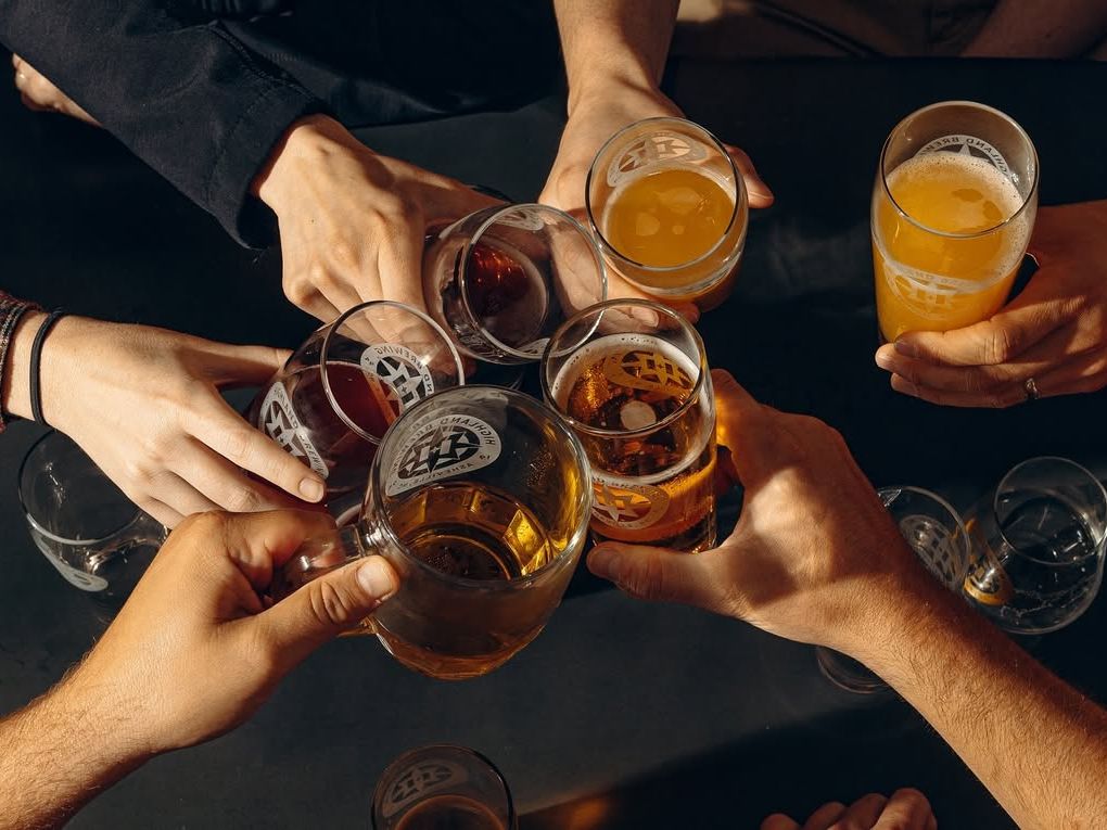 Friends raise their glasses for a group cheers at Highland Brewing, one of Asheville’s most loved local breweries. With craft beers and a chill vibe, it’s the place to celebrate good times and great brews.