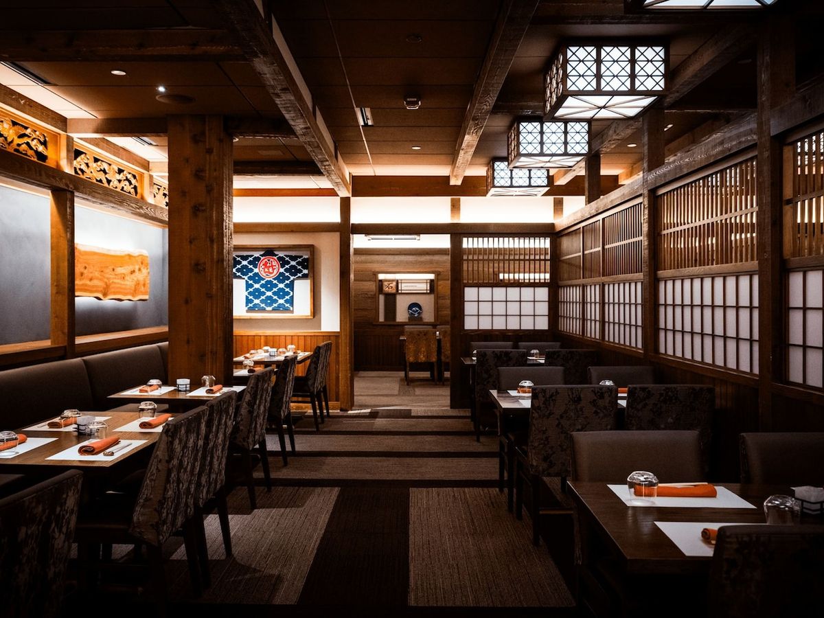 Elegant Japanese dining room at Takumi-Tei with warm wood accents, shoji screens, and refined décor. A fine dining experience inspired by Japanese tradition.