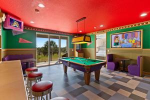 Simpsons themed game room with pool table and windows overlooking Orlando area