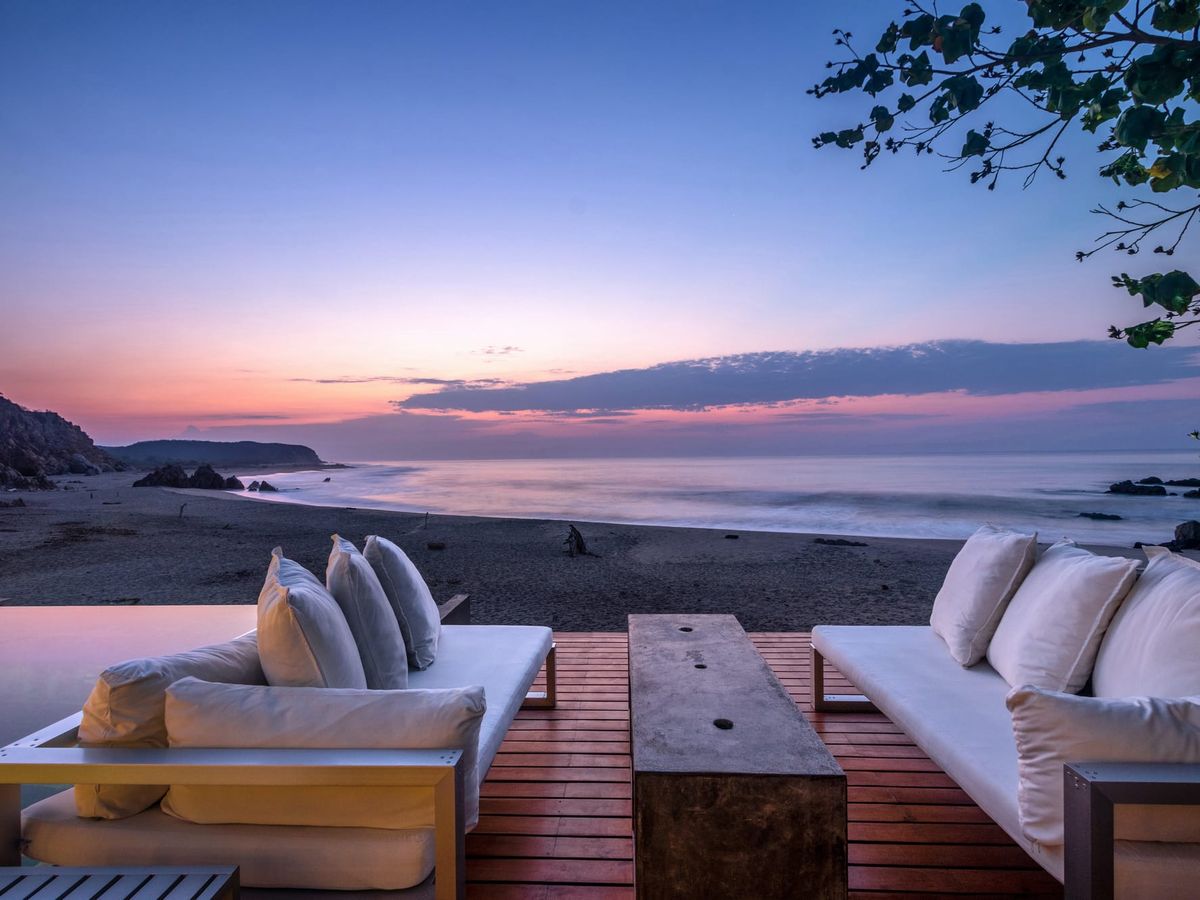 Sunset over a quiet beach in Huatulco with soft waves and a peaceful horizon. A serene image showing the beauty and safety of this coastal town.