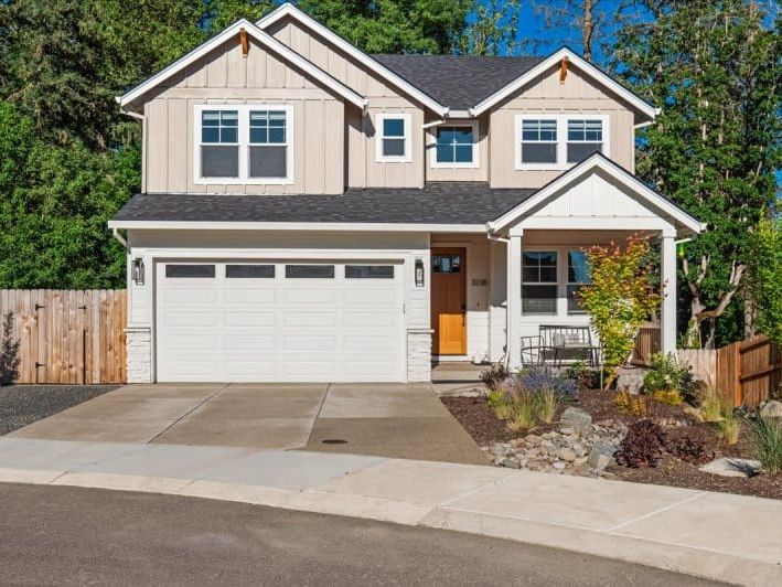 A charming modern house with clean lines and bright interiors, perfect for a peaceful escape. The front porch and well-kept yard give it that warm, welcome-home feel.
