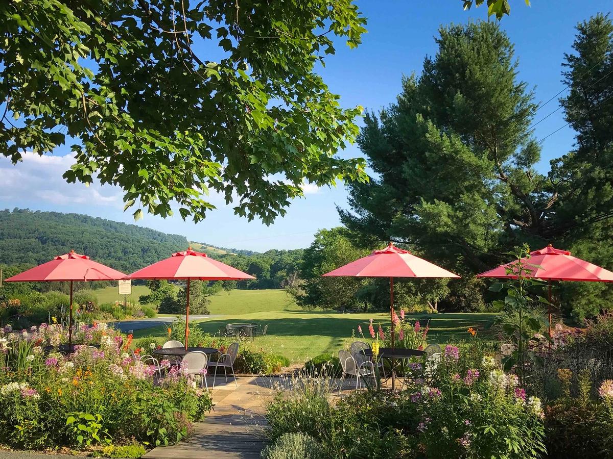 Jefferson Vineyards in Charlottesville with tables with Flowers and Red Umbrellas