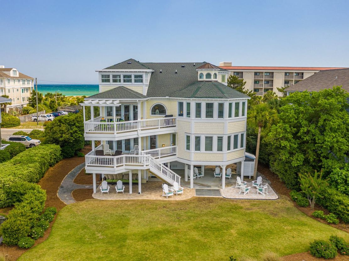 This Wrightsville Beach retreat welcomes dogs and features both canal and ocean views. Relax in the sunroom, enjoy the fire pit in the backyard, or launch your kayak right from the private dock.