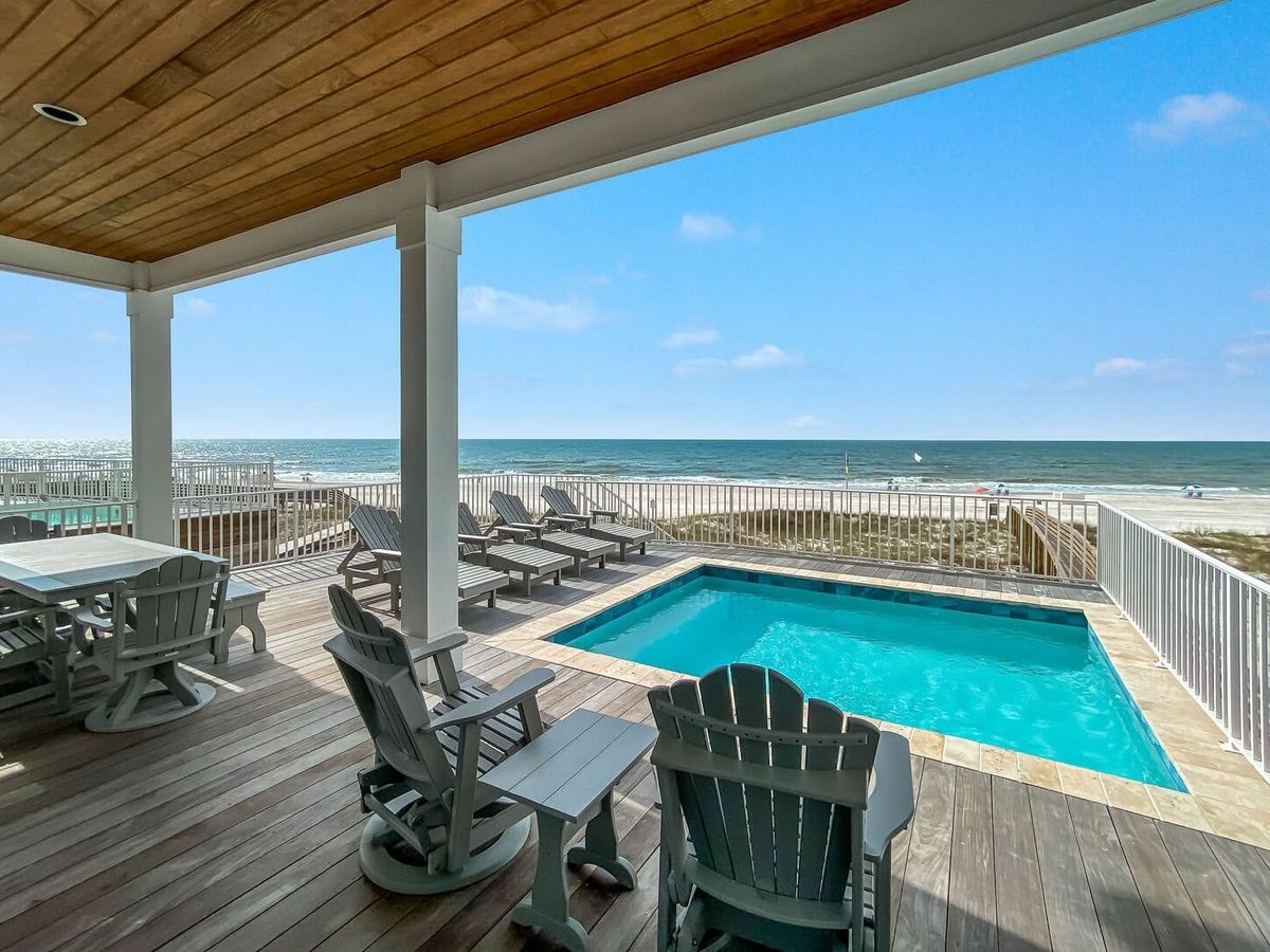 Back patio of vacation rental with beach views and private pool
