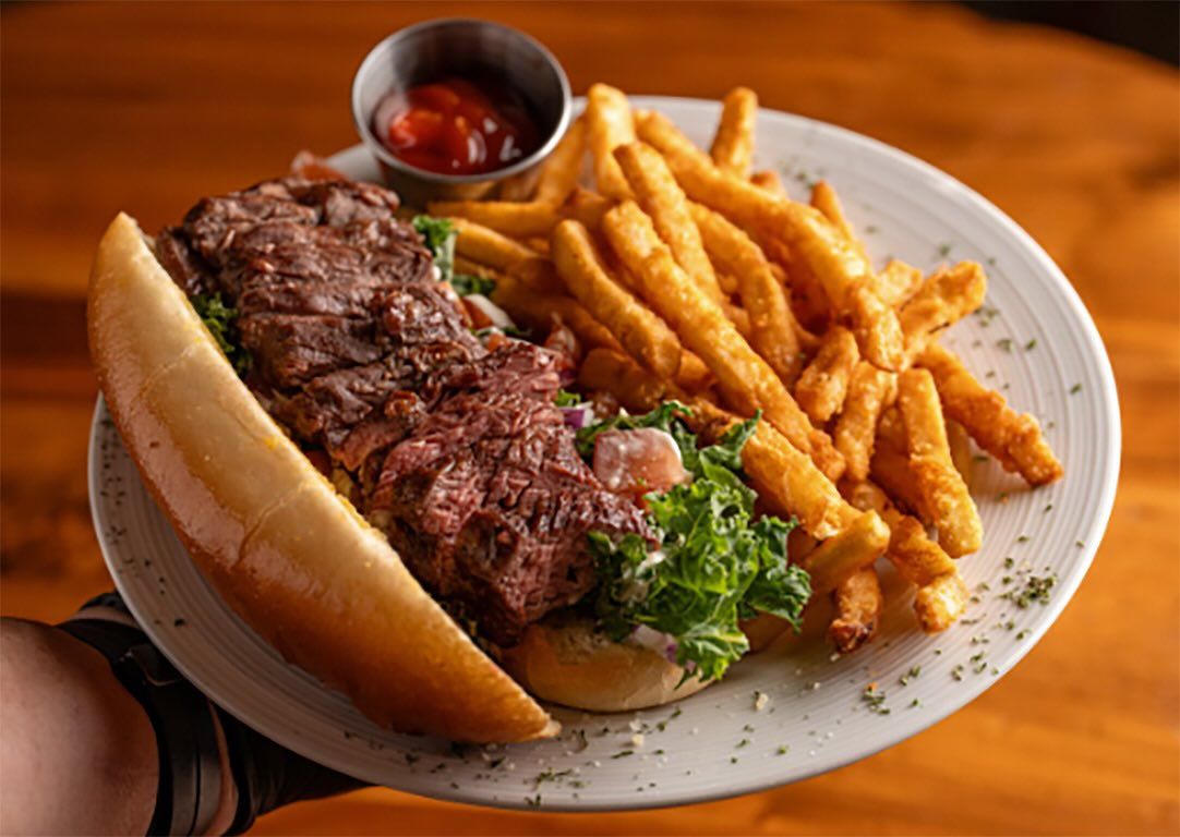 A table filled with vibrant dishes including grilled meats, rice, vegetables, and small plates ready to share. The variety of flavors reflects the lively atmosphere of Brazilian-style dining. Restaurants like this offer a fun experience where guests can enjoy multiple dishes in one meal.