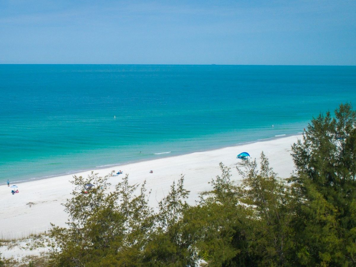 Manatee Public Beach lined with chairs and umbrellas, offering great amenities for families on Anna Maria Island.