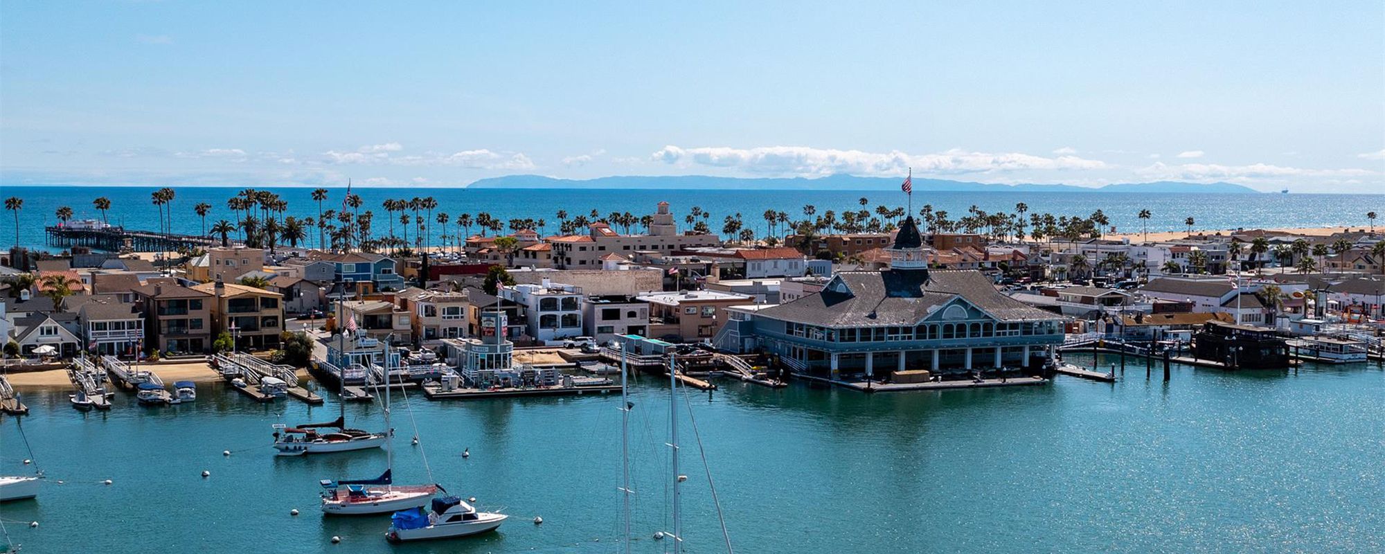 View of Luxury Waterfront Houses and Boats in Newport Beach, CA