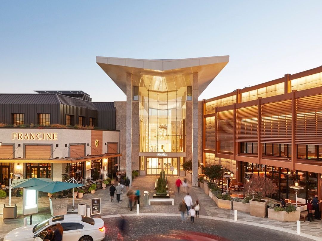 Shoppers walk through Scottsdale Fashion Square, a popular luxury shopping destination in Scottsdale, Arizona. The open-air setting, modern design, and palm-lined walkways make it a top spot for shopping, dining, and people-watching.
