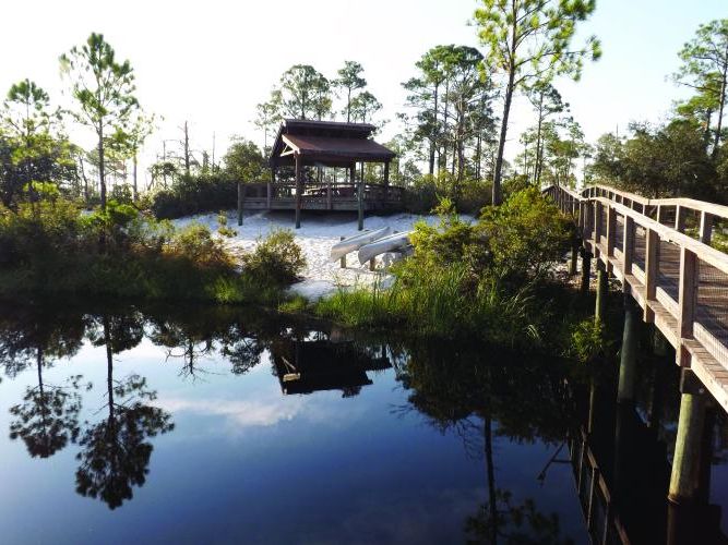 A quiet boardwalk and pavilion overlook the water at Big Lagoon State Park, a nature lover’s paradise with trails, kayaking, and birdwatching.