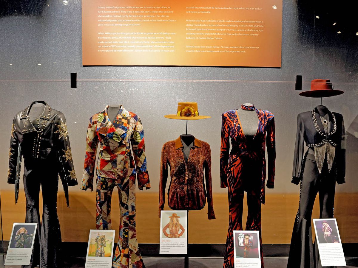 A display of bold, colorful stage outfits shows off the signature style of country music performers. Sequins, patterns, and hats give the exhibit a fun and nostalgic feel. Each outfit tells a story of the artist who wore it, capturing the heart of Nashville’s music scene.