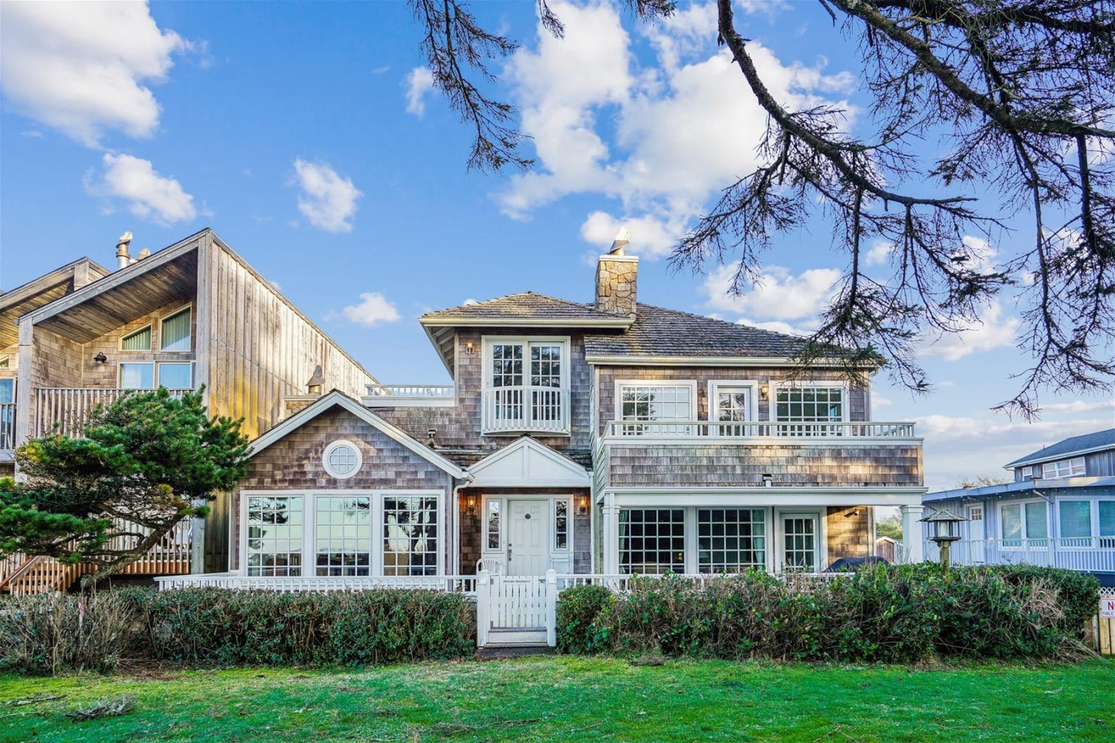 A classic shingle-style beach home with multiple balconies and charming coastal details. Surrounded by greenery and ocean air, it offers both elegance and a true seaside experience.