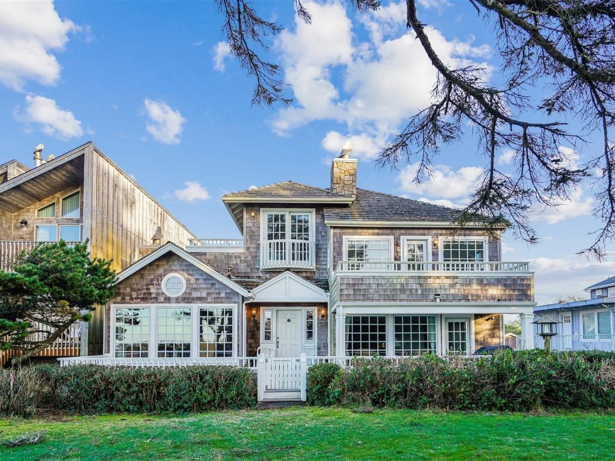 A classic shingle-style beach home with multiple balconies and charming coastal details. Surrounded by greenery and ocean air, it offers both elegance and a true seaside experience.