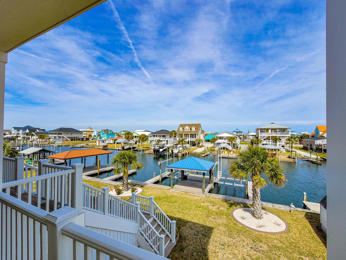 View of canal and boat docks from deck of a luxury Topsail Island Vacation Rental