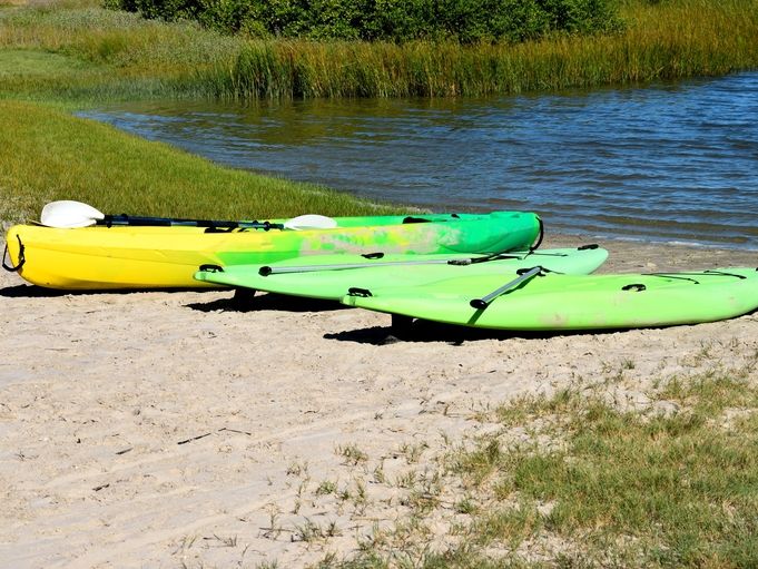 Paddleboards and Kayak on Beach near River