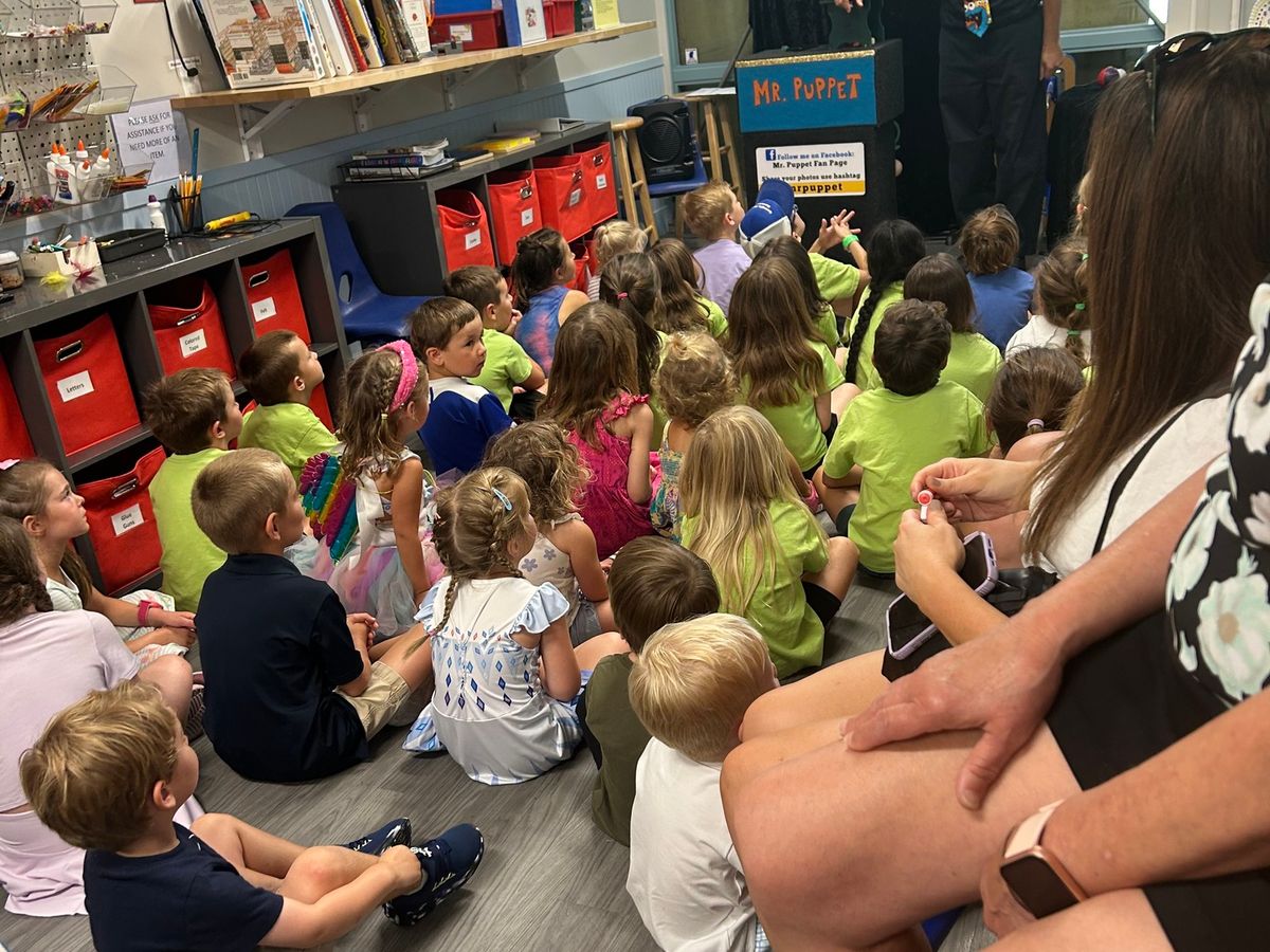 Children sit together watching a lively puppet show at The Sandbox Children’s Museum on Hilton Head Island. This hands-on museum encourages creativity and imagination with interactive exhibits and fun learning spaces.