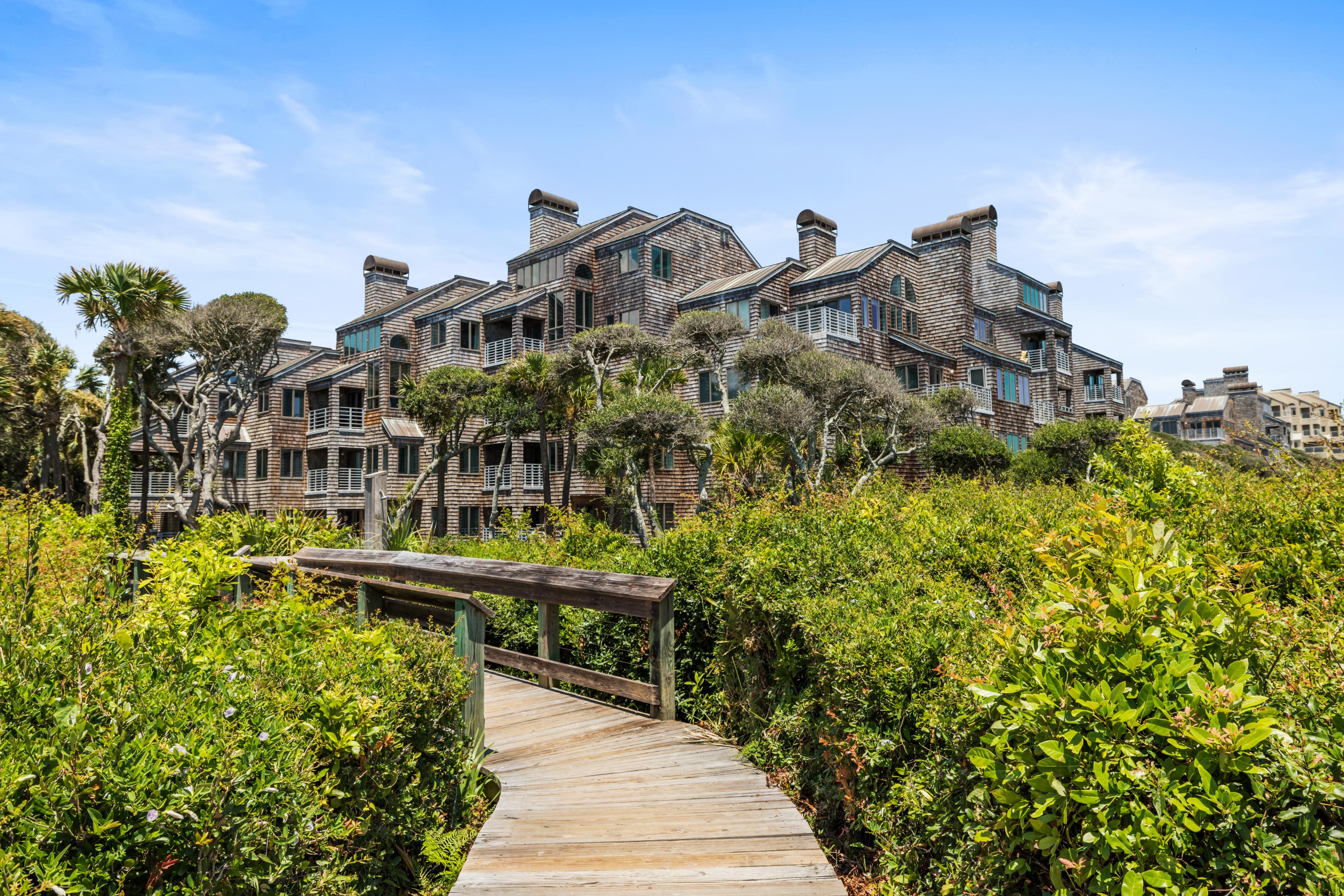 Wooden boardwalk leading from beach to vacation homes
