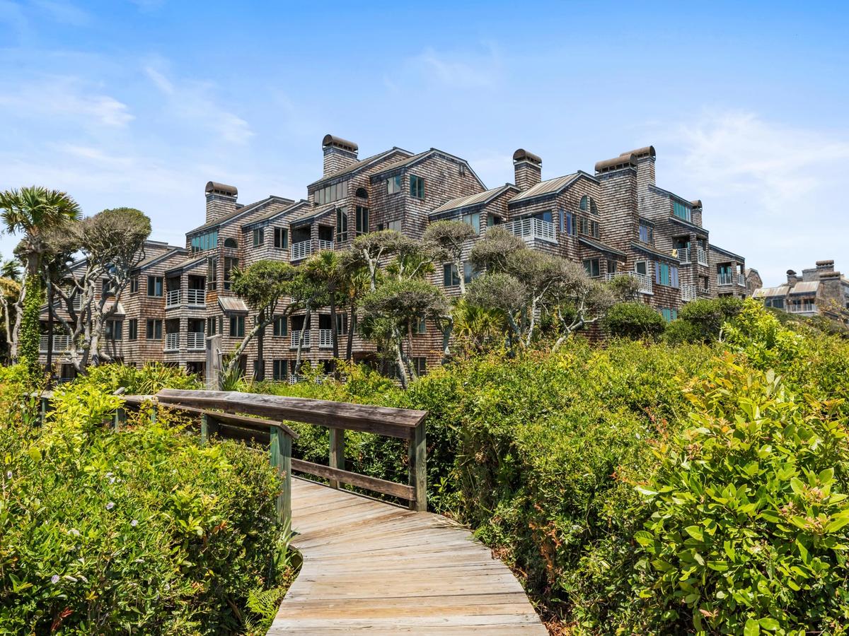 Wooden boardwalk leading from beach to vacation homes