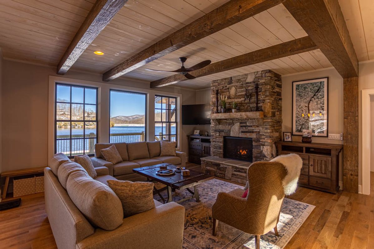 Living room with a fireplace and lake views.