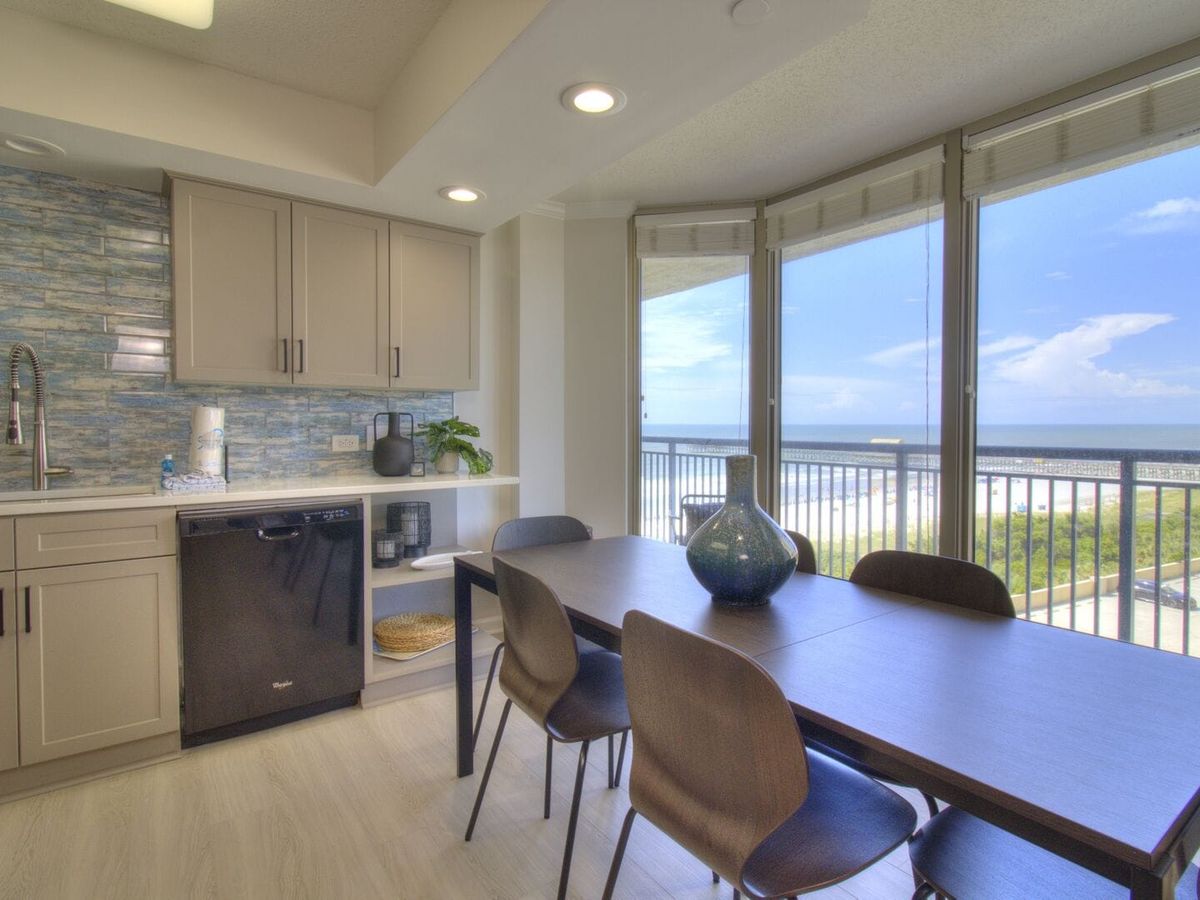 Stylish dining area with modern decor and giant windows that show off the beach. Whether you’re having breakfast or just chatting with friends, this view never gets old.