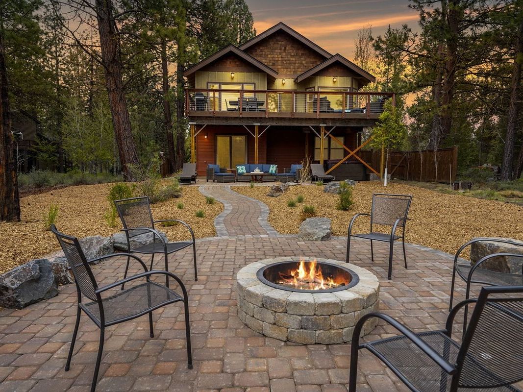 This spacious luxury cabin is built for gatherings, with a beautiful outdoor firepit overlooking the forest and river. The upper deck features ample seating for dining and lounging while enjoying sunset views. Inside, vaulted ceilings and large living areas make it ideal for family reunions or group retreats.