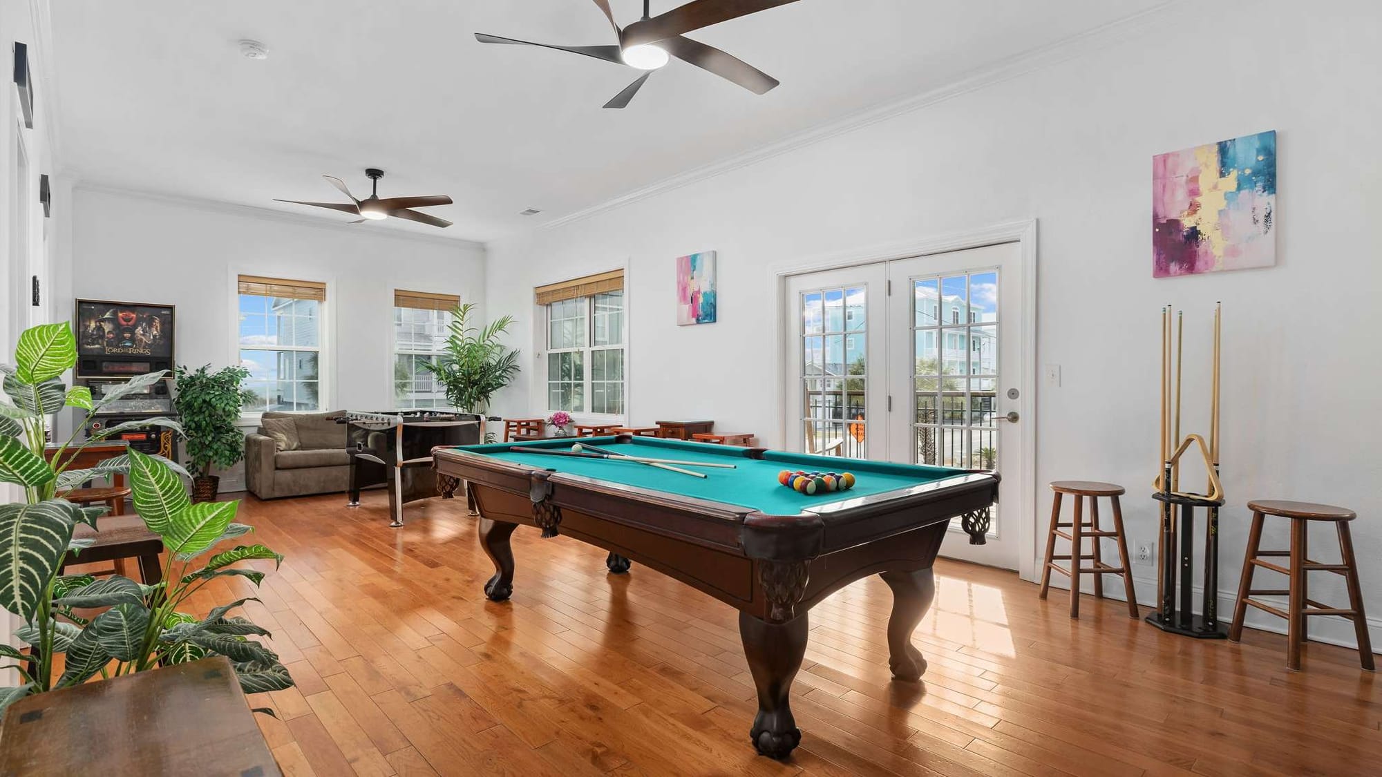 Game room with a full-size pool table offers fun indoor entertainment for guests of all ages. Large windows and comfortable seating create a bright space perfect for friendly competitions and family time.