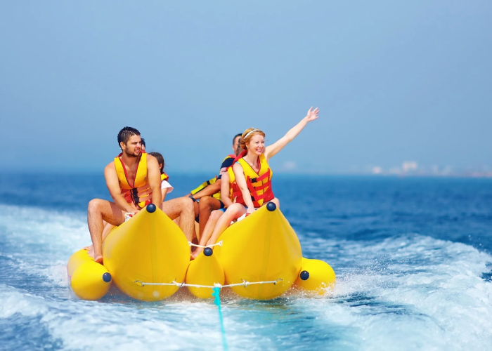 A group of friends laugh and hold on tight as their banana boat speeds across the sparkling ocean. It’s the perfect mix of sunshine, excitement, and tropical fun in the Bahamas.