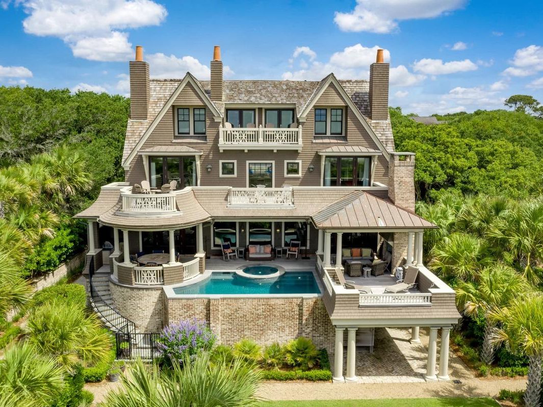 : A grand vacation estate featuring multiple stories, private balconies, and a stunning pool with ocean views. Designed to host large groups, the home offers spacious living areas and luxury finishes. Perfect for family reunions or gatherings by the beach.