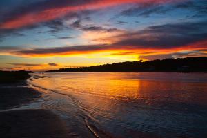 Sunset going down at Ocean Isle NC with the water calmly washing on the shore