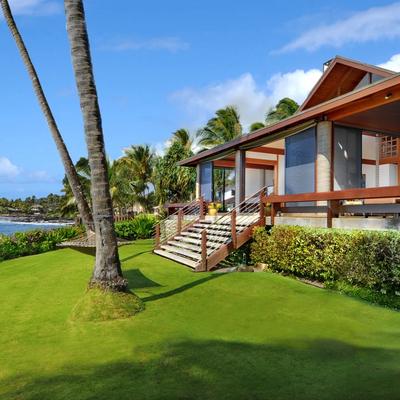 Frontyard with lush green grass with oceanfront view