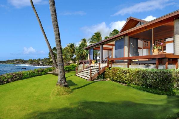 Frontyard with lush green grass with oceanfront view