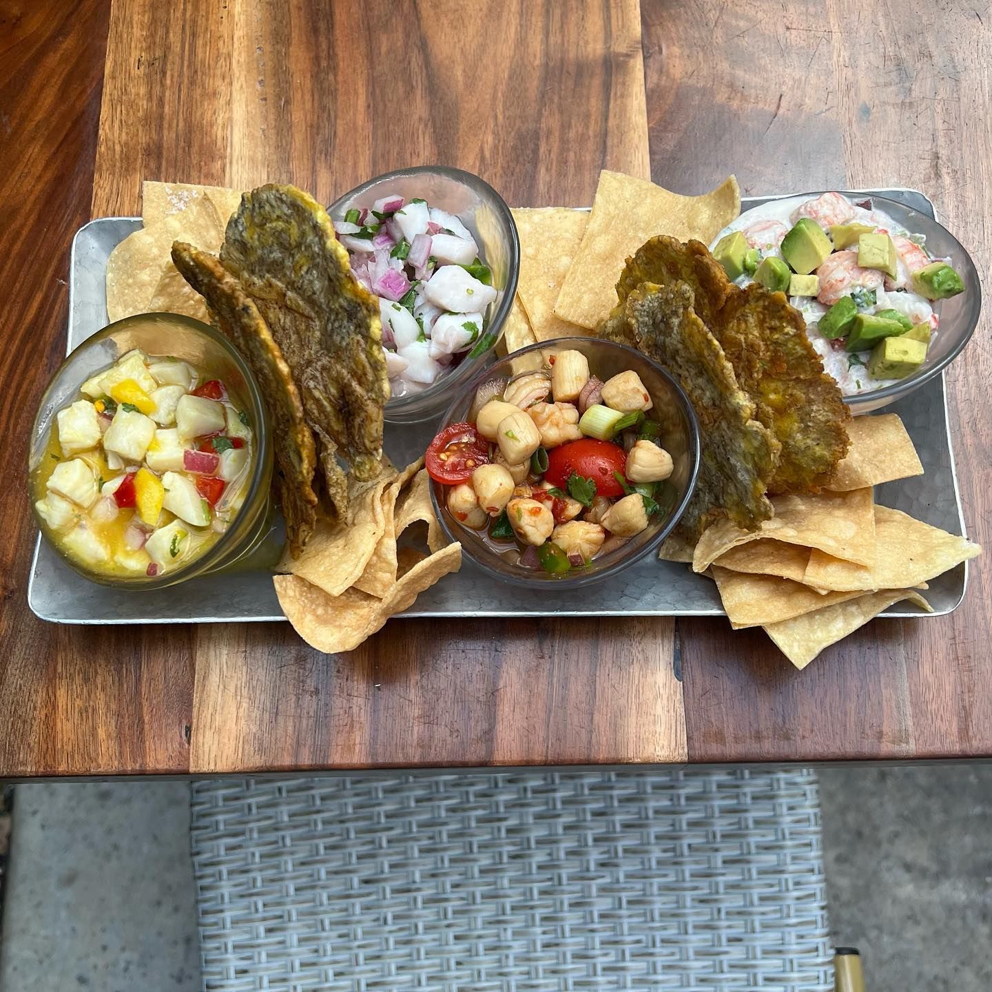 A sampler tray of tropical ceviche featuring shrimp, scallops, and avocado served with crispy plantain chips. Bright, colorful, and full of flavor—Ceviche’s brings Latin-inspired freshness to the Carolina coast.