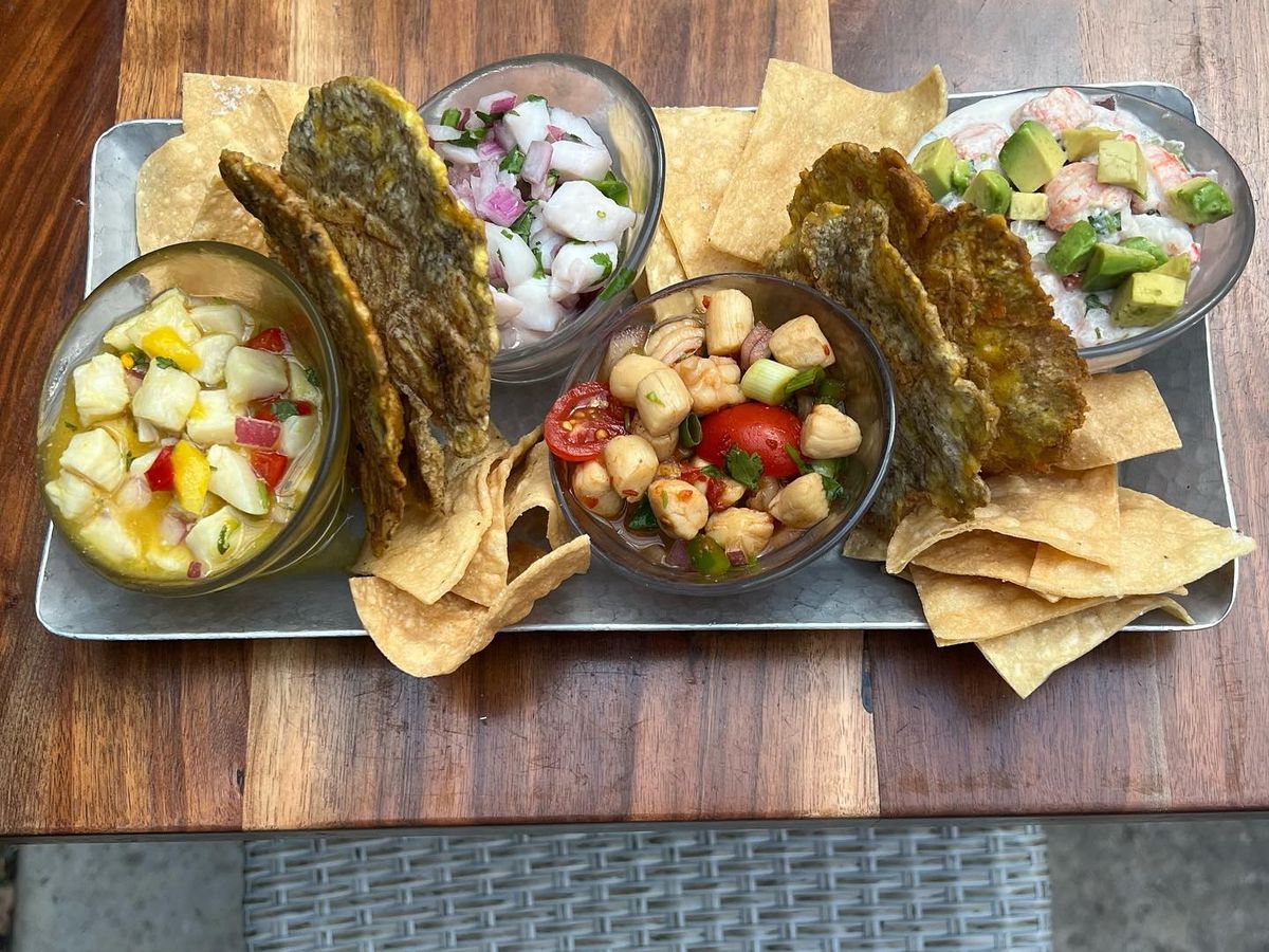 A sampler tray of tropical ceviche featuring shrimp, scallops, and avocado served with crispy plantain chips. Bright, colorful, and full of flavor—Ceviche’s brings Latin-inspired freshness to the Carolina coast.