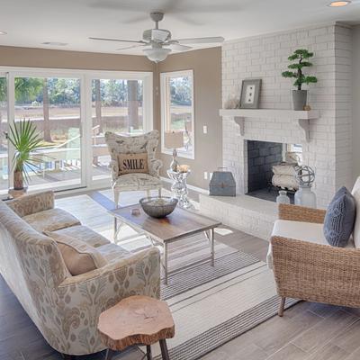 Living room with a fireplace overlooking a private pool.