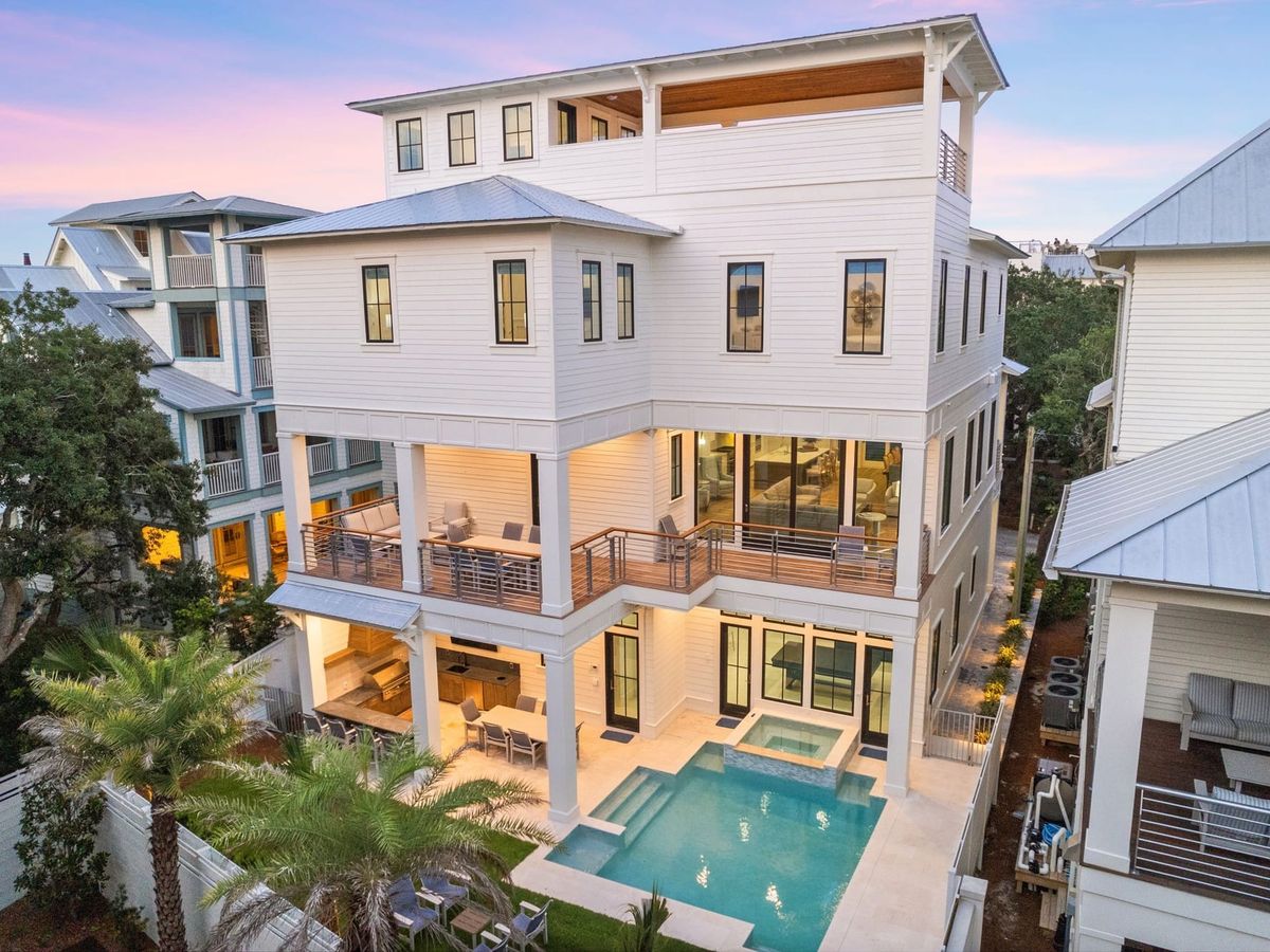 A grand coastal home on Florida’s Emerald Coast featuring multiple balconies, open living spaces, and a private pool. Designed for large groups, it’s a serene yet luxurious seaside escape.