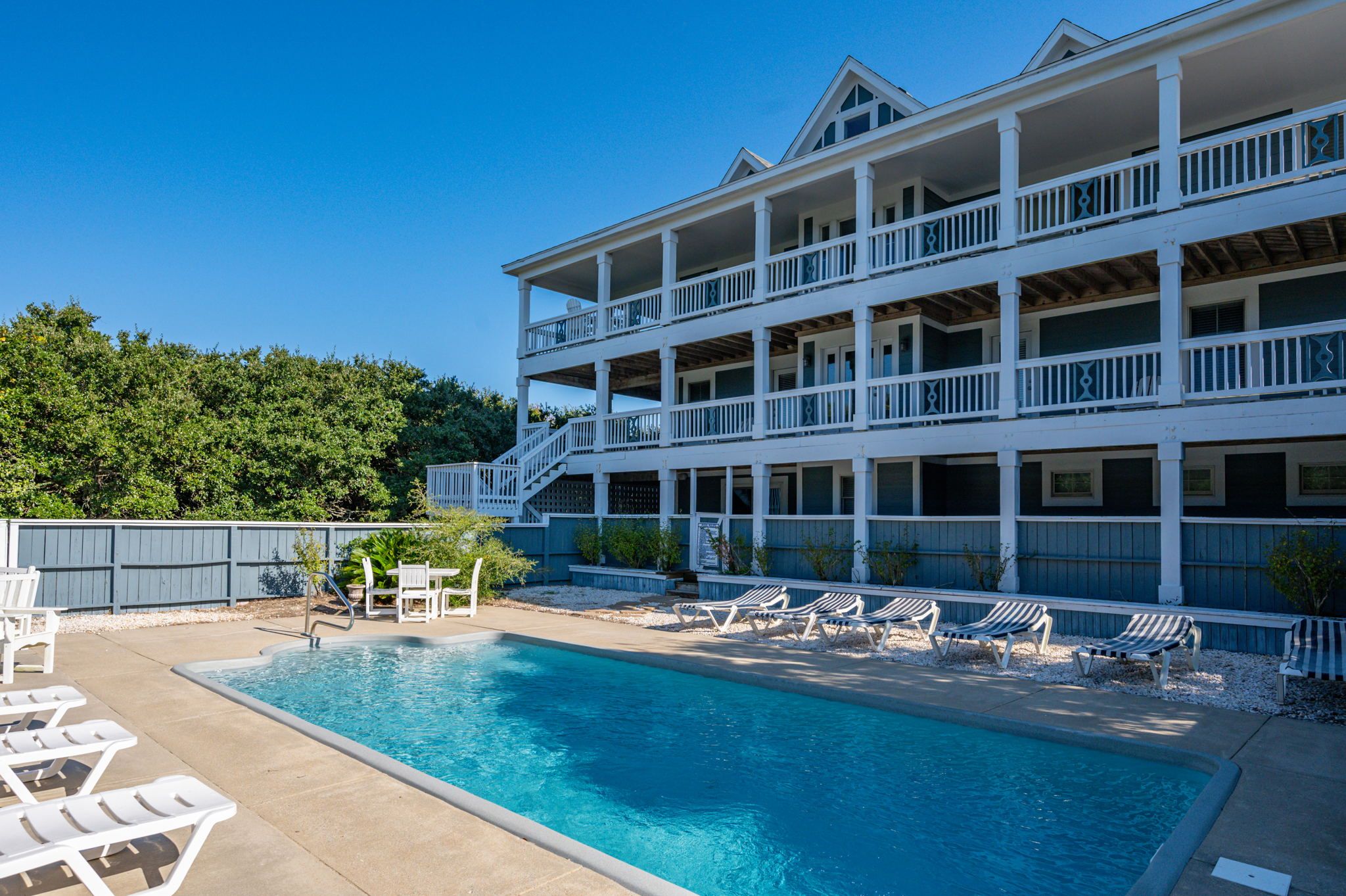 Private pool with chairs next to it and large balcony