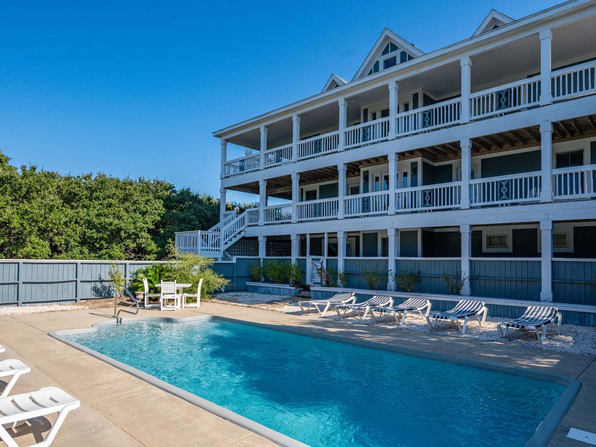 Private pool with chairs next to it and large balcony