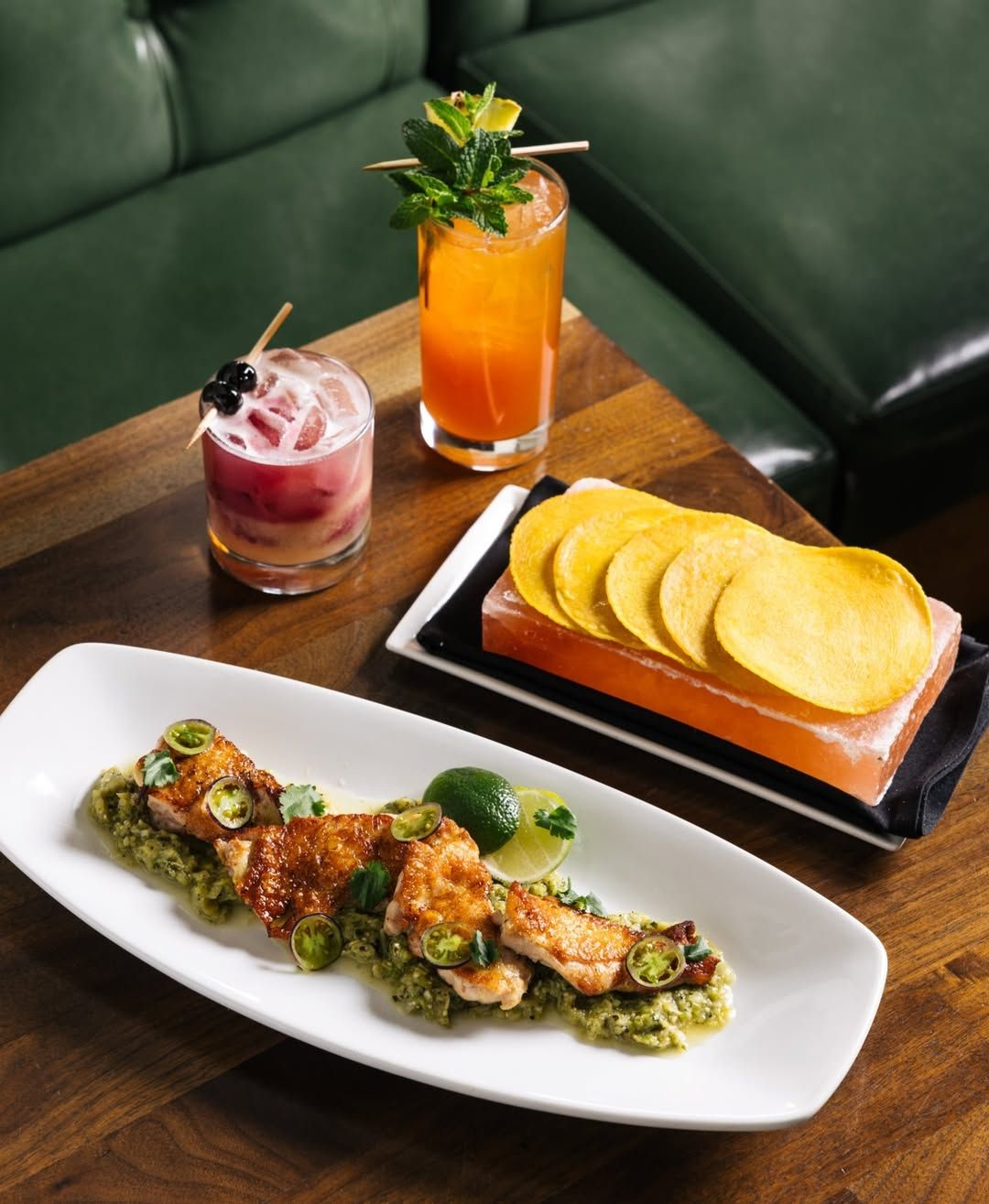 A beautifully plated meal and cocktails at The Mission Old Town highlight modern Latin flavors. The dim lighting and upscale setting make it a go-to Scottsdale restaurant for date nights and special dinners.