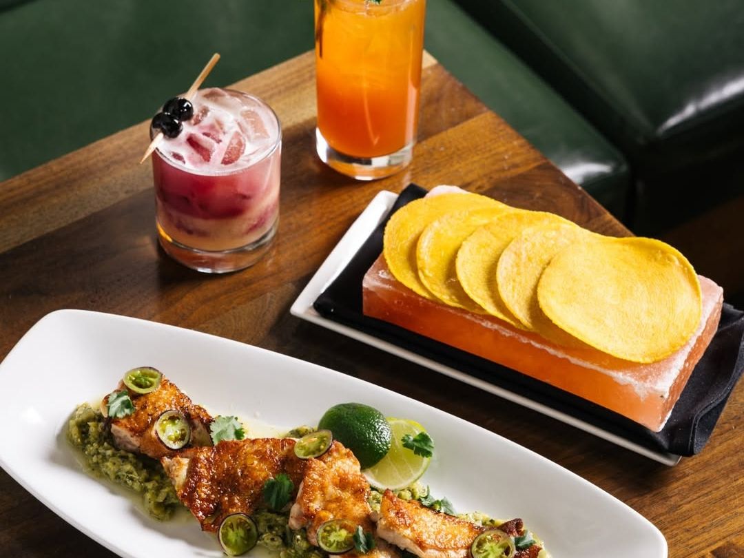 A beautifully plated meal and cocktails at The Mission Old Town highlight modern Latin flavors. The dim lighting and upscale setting make it a go-to Scottsdale restaurant for date nights and special dinners.