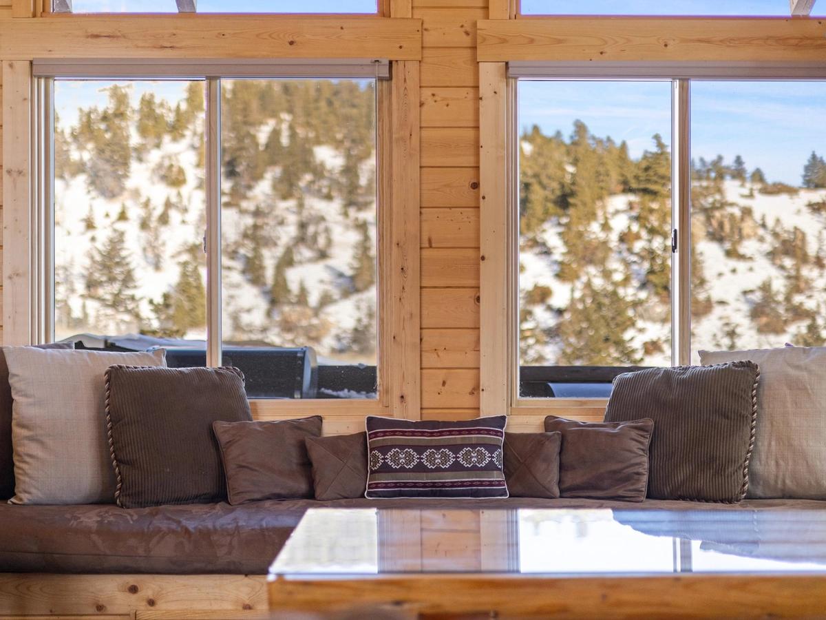 Reading nook with window overlooking snowy mountains and trees in montana