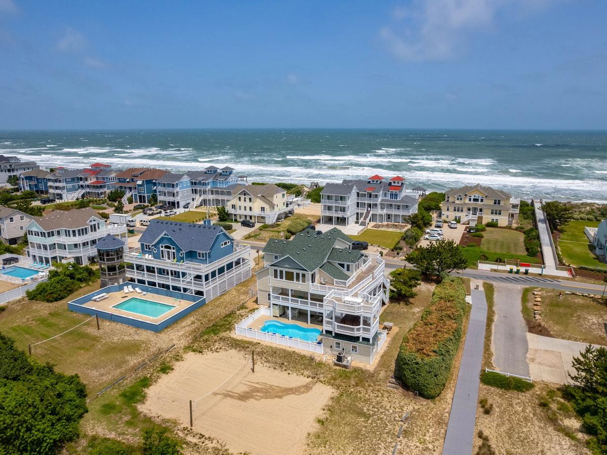 Three homes side by side with private pools and ocean in the background