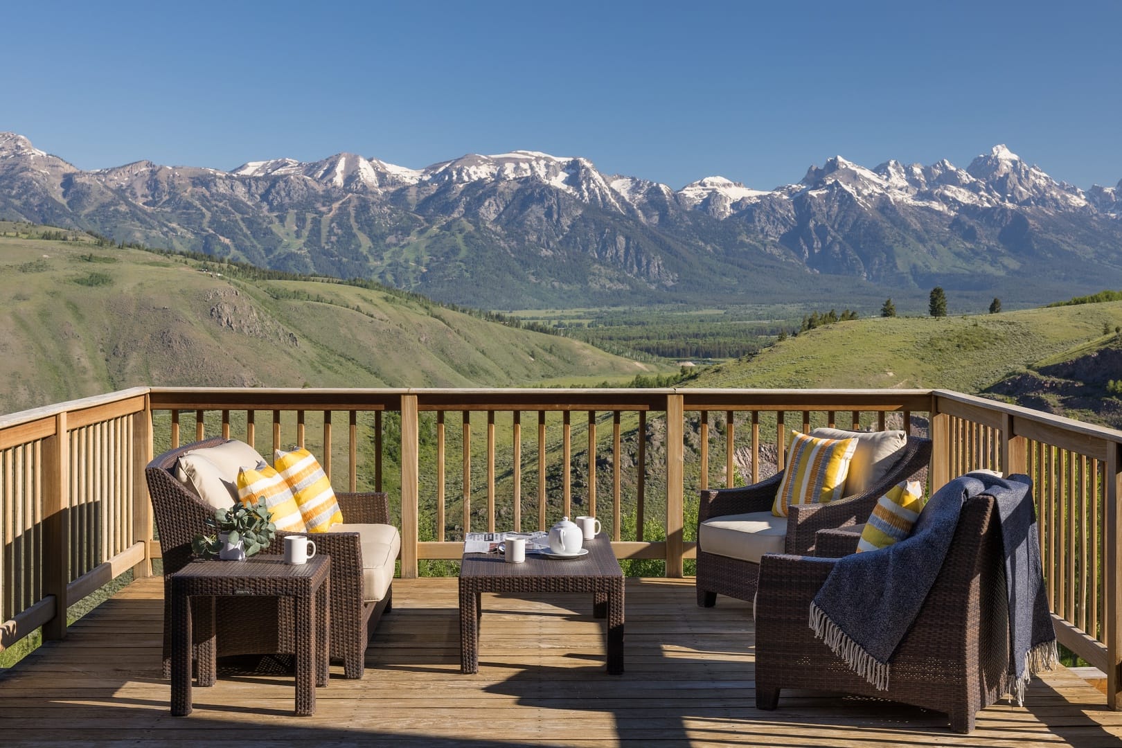 This cozy deck looks out over sweeping mountain views, with comfy chairs set up for slow mornings and warm conversations. The bright pillows and fresh air create a peaceful place to start or end your day. It’s a simple, beautiful reminder of why family trips to the mountains feel unforgettable.
