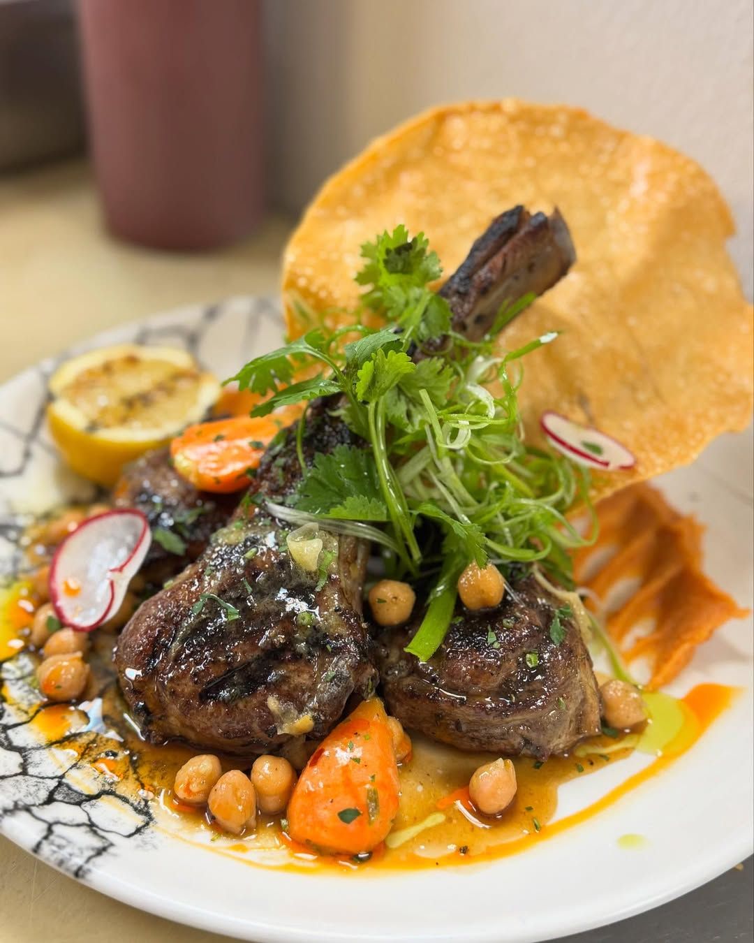 A hearty steak sandwich served with crispy fries and fresh greens on a wooden table. The dish highlights the bold flavors and generous portions many local restaurants offer. It’s the kind of comfort food that pairs perfectly with a casual lunch or dinner out.