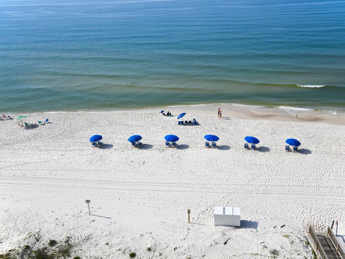 View of Gulf Shores Beach with Beach Chairs and Umbrellas
