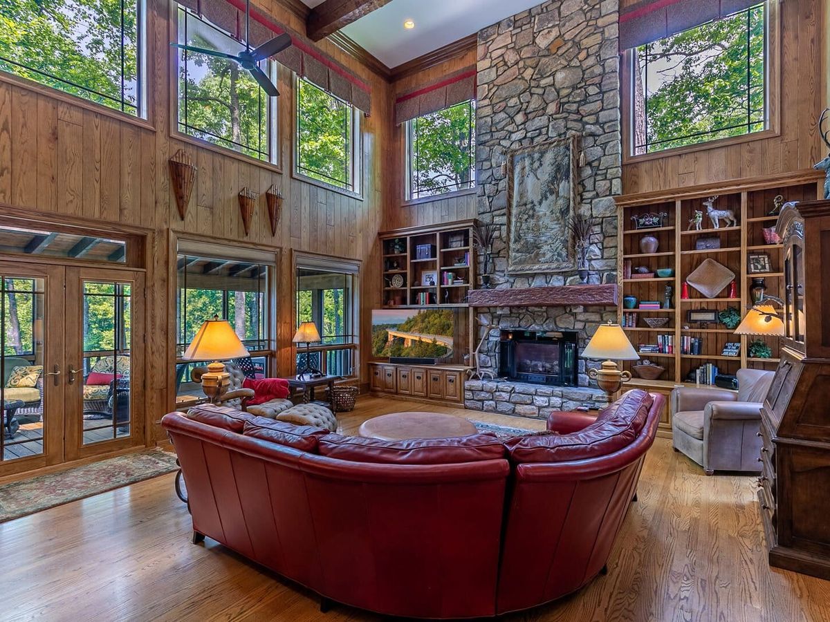 Modern mountain home exterior at Amitola at Yonahlossee, featuring clean lines, warm wood accents, and sunset views over the Blue Ridge Mountains. This luxury retreat blends contemporary design with a peaceful mountain setting.